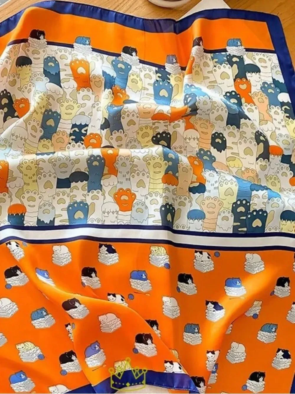 Playful Cat Paw Scarf in Orange & Navy feels like silk is polyester